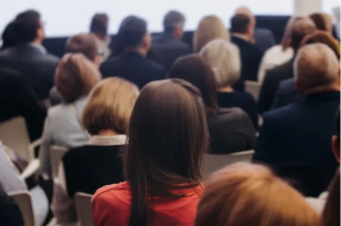 Audience attending an estate planning workshop, focusing on individuals engaged in learning about wills and trusts.