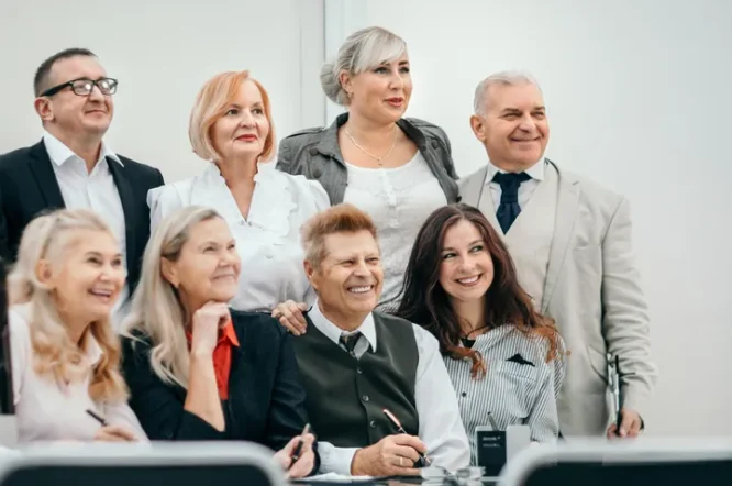 Group of diverse individuals smiling together, representing Legacy Peace's community engagement in estate planning education workshops and webinars.